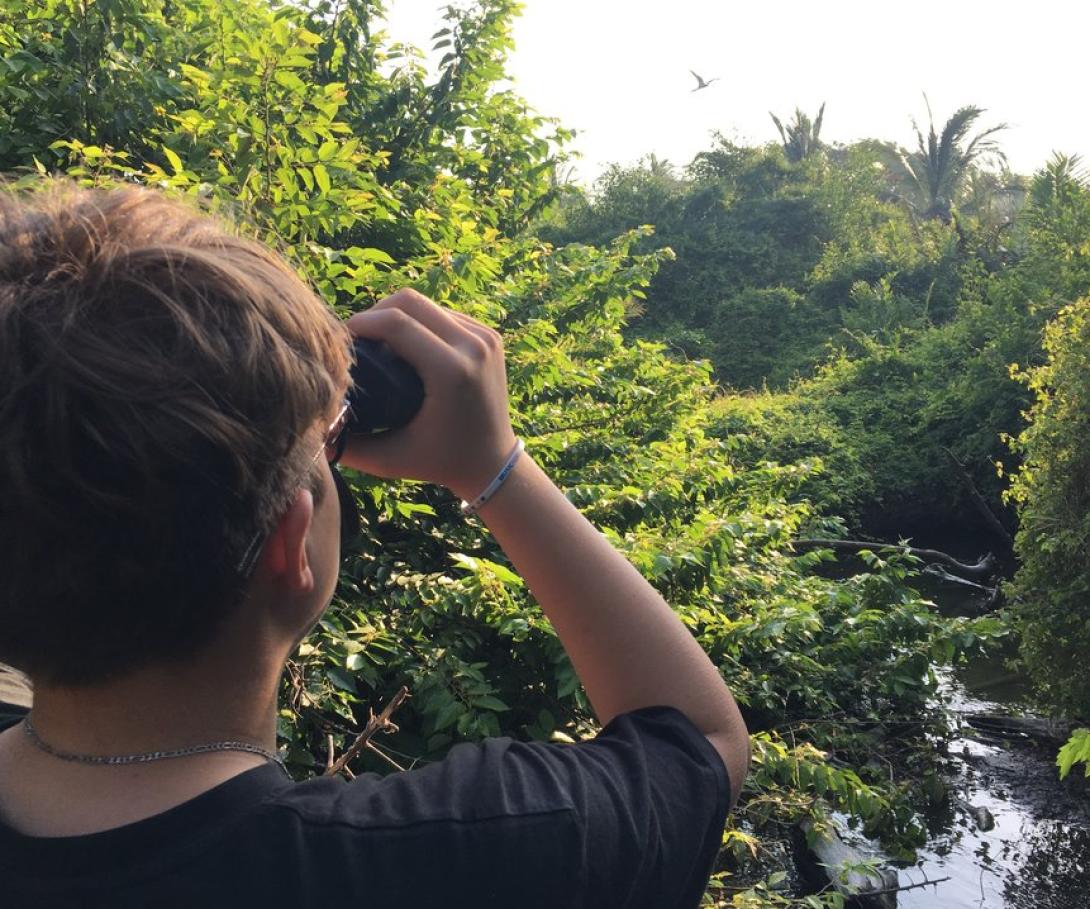 A teenager on a tailor-made volunteer trip for his school participates in a bird survey in Mexico. A high school student on a bespoke group trip with his peers observes birds in Mexico.